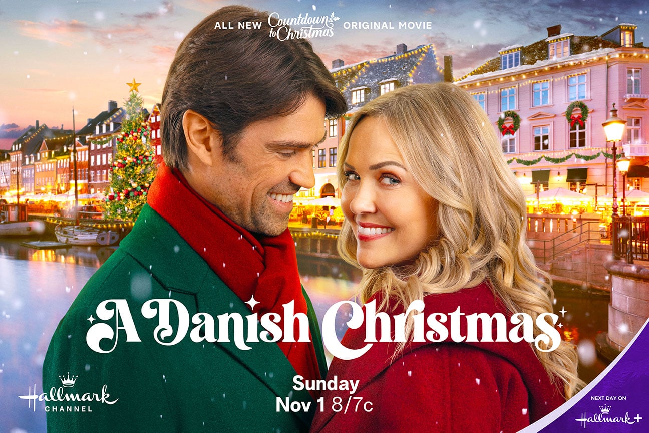 Corey Sevier and Emilie Ullerup in Hallmark Channel's A Danish Christmas key art in front of Copenhagen's Nyhavn