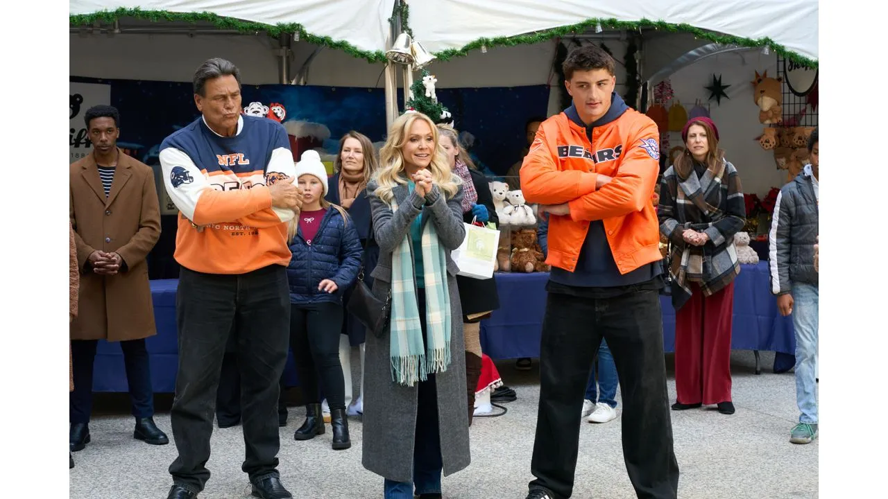 Group of people at an outdoor holiday market two men in orange jackets stand with arms crossed a woman in a gray coat and scarf between them