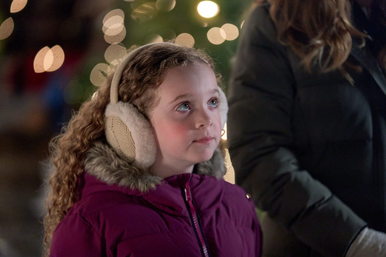 Taylor Blake as Leah looks up at the Christmas lights in Adopting St Nick