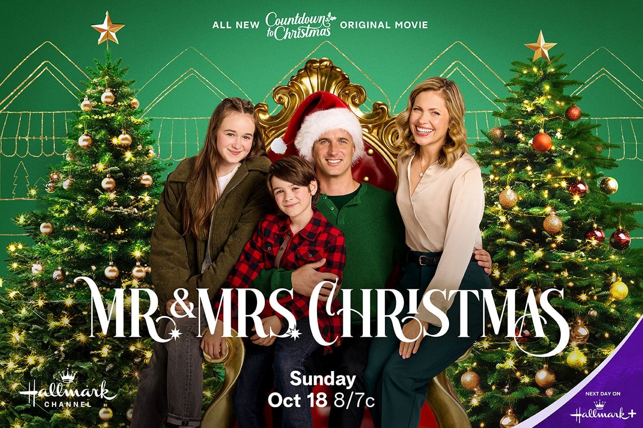 Family of four sits together in front of two decorated Christmas trees with the bold movie title MR  MRS CHRISTMAS and Hallmark branding promoting a Christmas film
