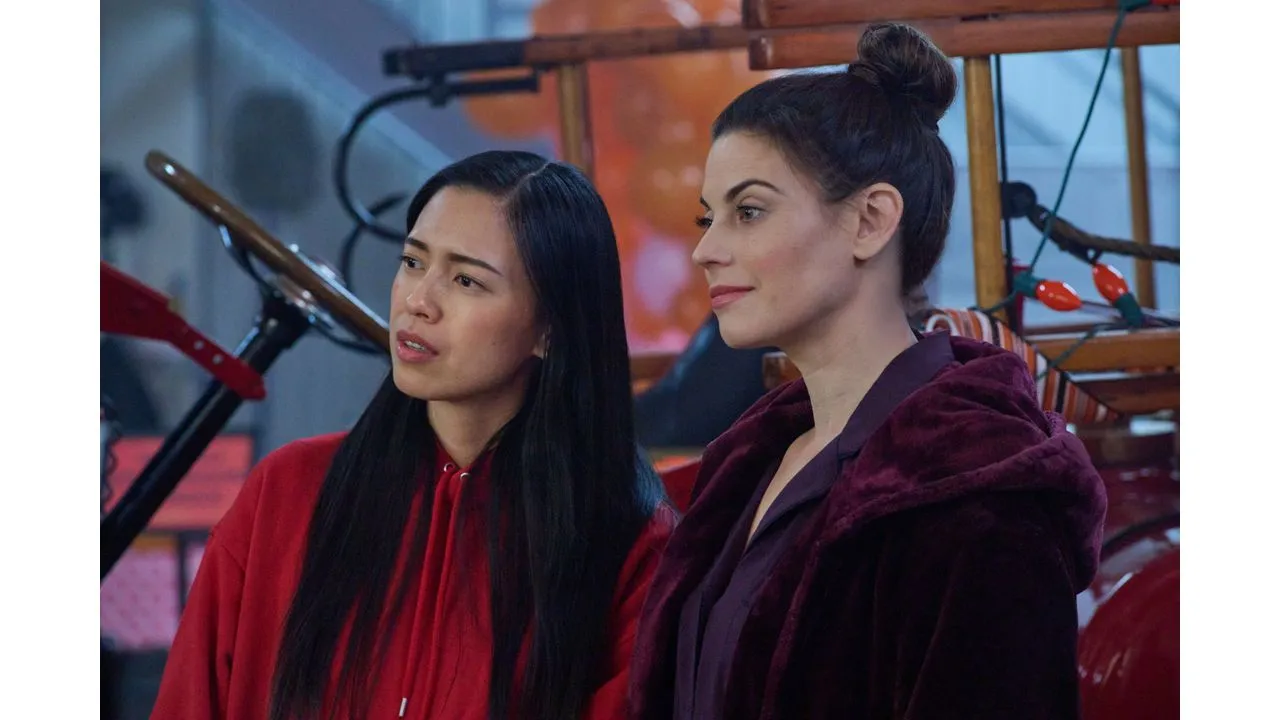 spiritofhalloween2 Fantasy Land News Two women stand side by side indoors one in a red hoodie and the other in a burgundy coat with a vintage bicycle in the background